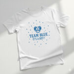 Blue "Team Boy" gender reveal t-shirt with royal crown and anchor graphics for a baby announcement.